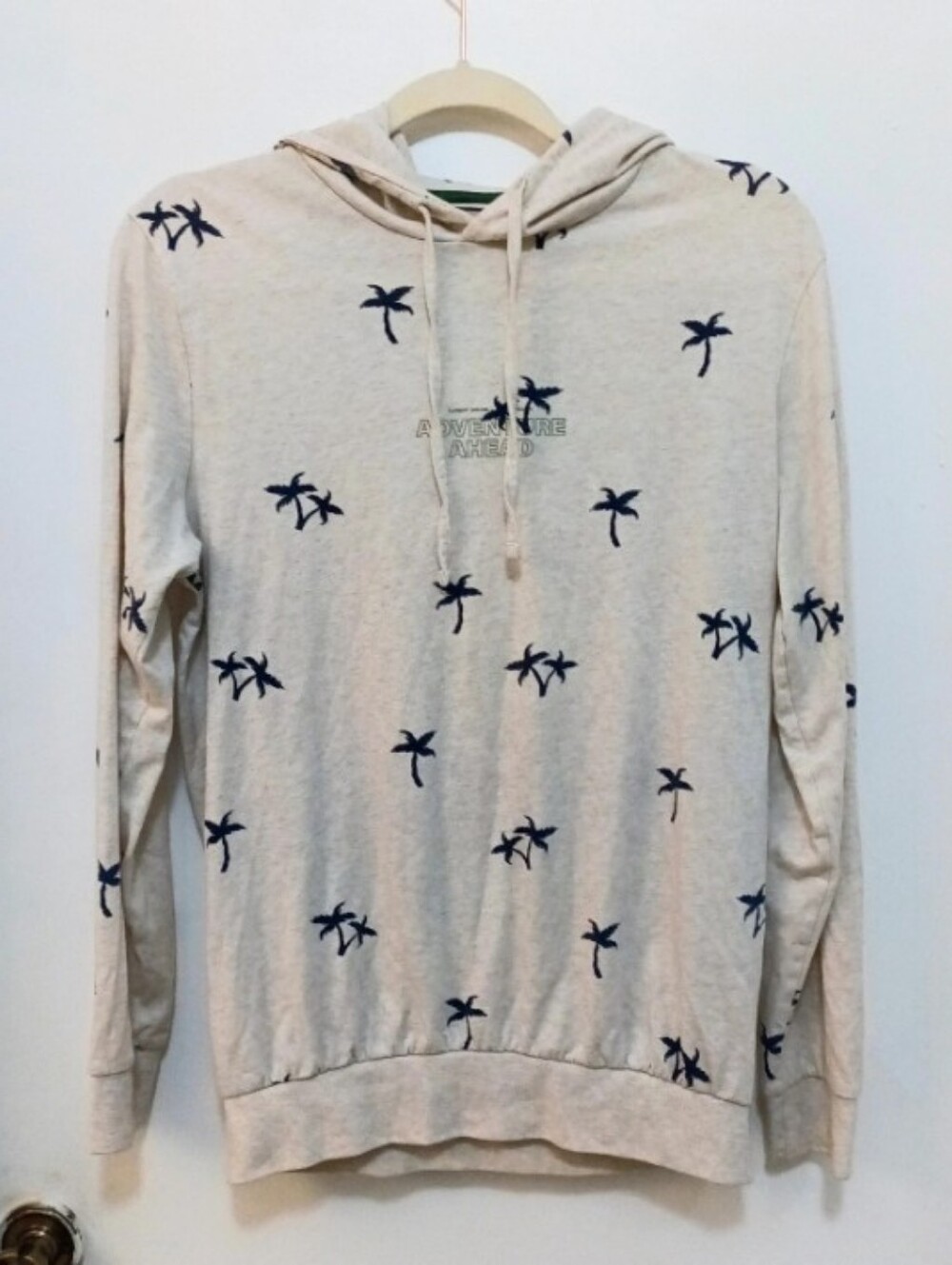 DENIM & FLOWER Ricky Singh Cream Hoodie with Navy Palms Detail.